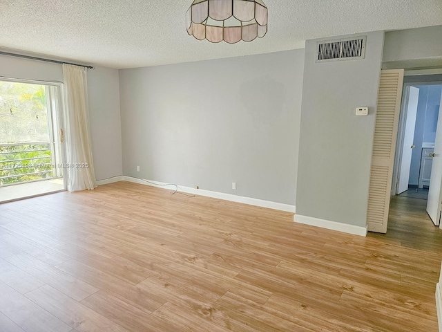 1000 NE 14th Ave Unit 404, Hallandale Beach, FL 33009 - spare room featuring a textured ceiling, light wood-style floors, and baseboards