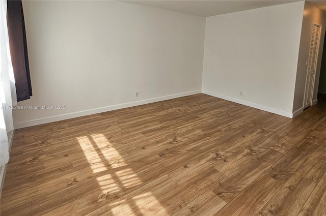 1000 NE 14th Ave Unit 404, Hallandale Beach, FL 33009 - unfurnished room with wood finished floors and baseboards