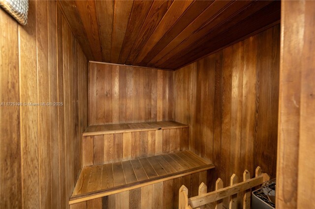 workout room with wooden ceiling, an AC wall unit, ceiling fan, wood-type flooring, and a skylight