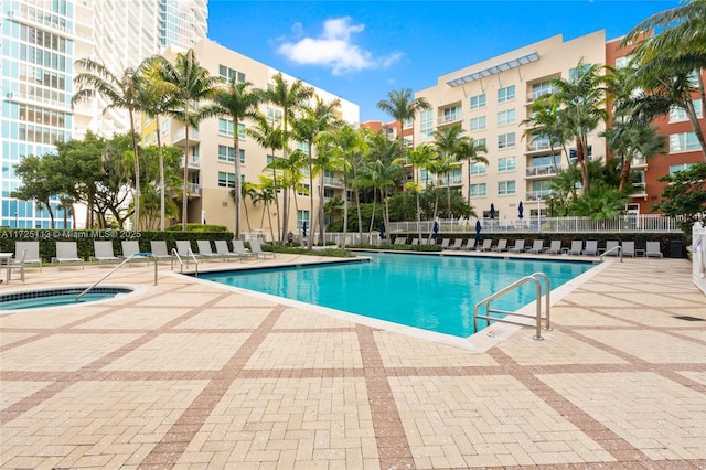 view of pool with a community hot tub and a patio area