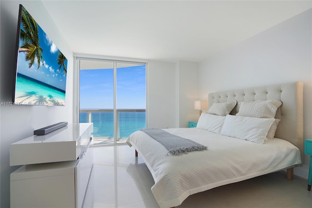 bedroom with access to outside, light tile patterned flooring, and expansive windows