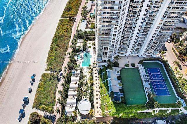 drone / aerial view with a beach view and a water view