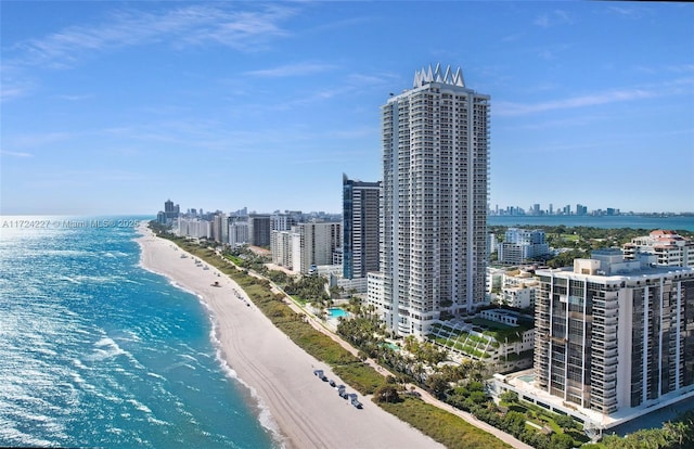 birds eye view of property with a beach view and a water view