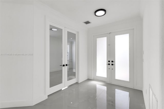 foyer entrance featuring ornamental molding and french doors