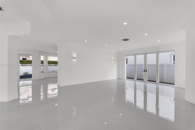 unfurnished room featuring french doors and crown molding