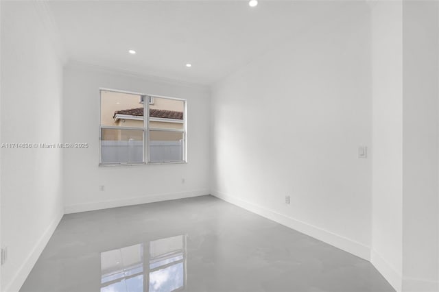 unfurnished room featuring concrete floors and ornamental molding