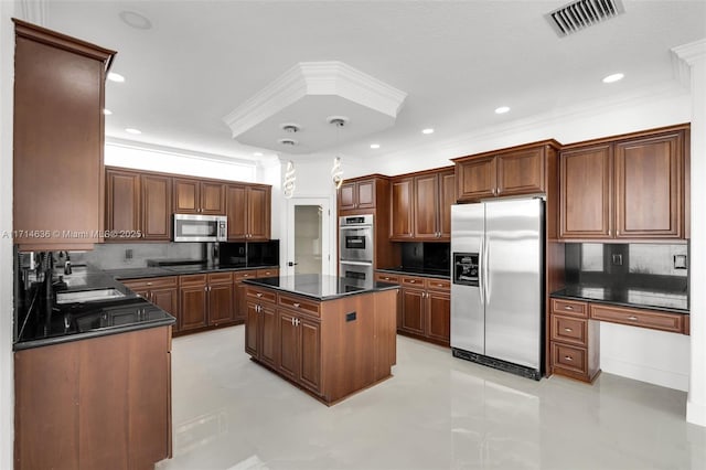 kitchen with a kitchen island, tasteful backsplash, and appliances with stainless steel finishes