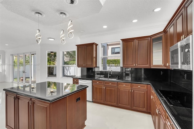 kitchen with stainless steel appliances, a textured ceiling, decorative backsplash, and sink