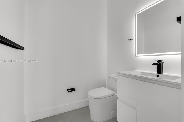 bathroom with toilet and vanity