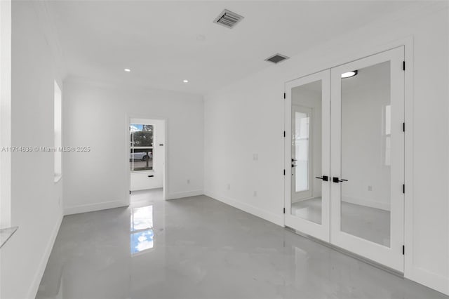 spare room with ornamental molding and french doors