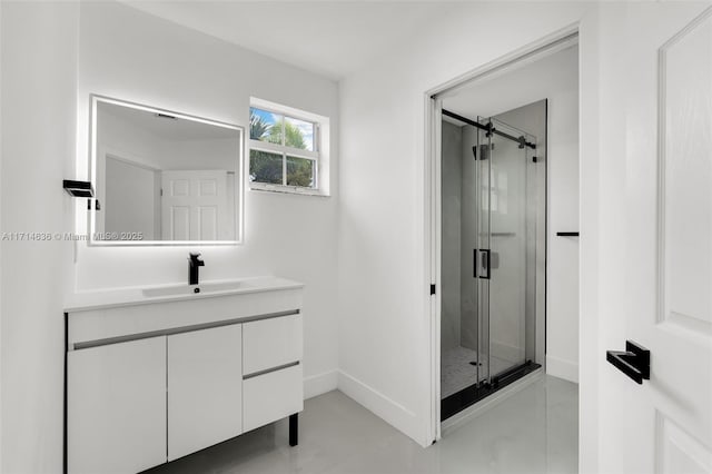 bathroom with a shower with door and vanity