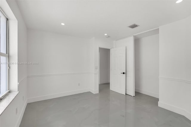 empty room with concrete flooring