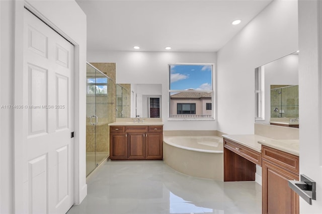 bathroom with vanity and shower with separate bathtub