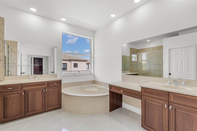 bathroom featuring separate shower and tub and vanity