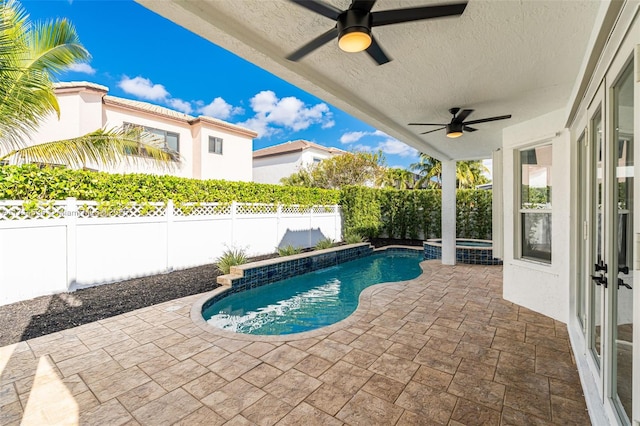 view of swimming pool featuring ceiling fan, an in ground hot tub, and a patio