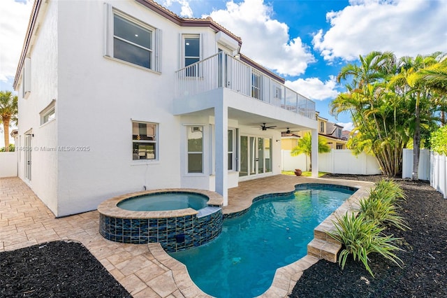 exterior space with a pool with hot tub, a balcony, a patio, and ceiling fan