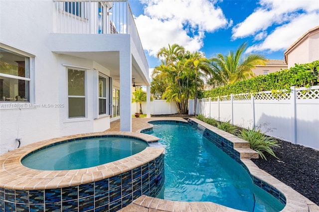 view of pool with an in ground hot tub