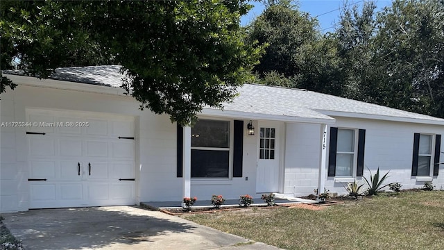 ranch-style home featuring a front yard and a garage