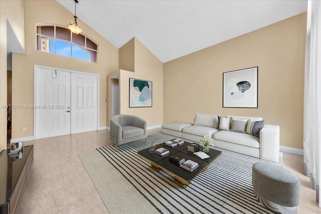 living room featuring high vaulted ceiling