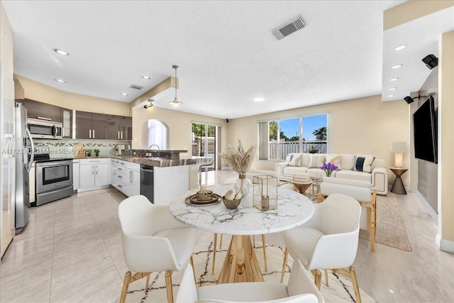 tiled dining room featuring sink