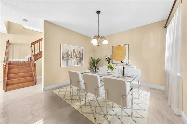 dining area featuring a textured ceiling and a notable chandelier