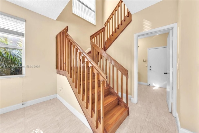 stairs featuring tile patterned flooring