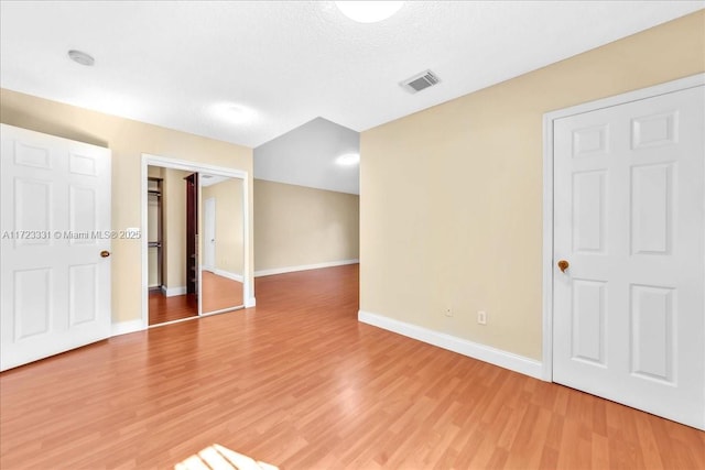 unfurnished room featuring a textured ceiling and hardwood / wood-style floors