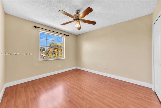 unfurnished room featuring a textured ceiling, ceiling fan, and light hardwood / wood-style flooring