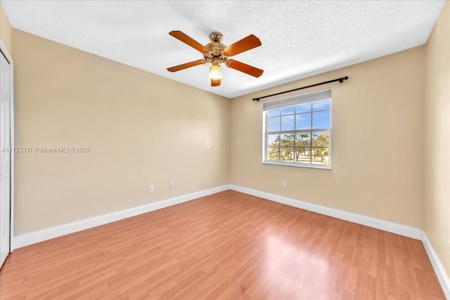 spare room featuring a textured ceiling, ceiling fan, and light hardwood / wood-style floors