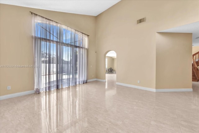 empty room featuring a high ceiling