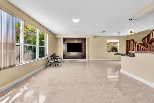 sitting room with a fireplace and light tile patterned flooring