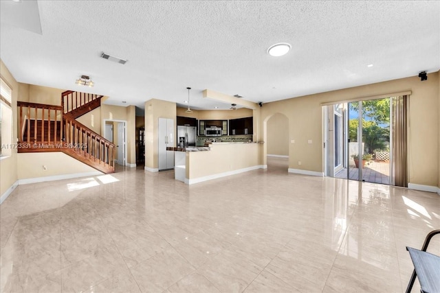 unfurnished living room with a textured ceiling