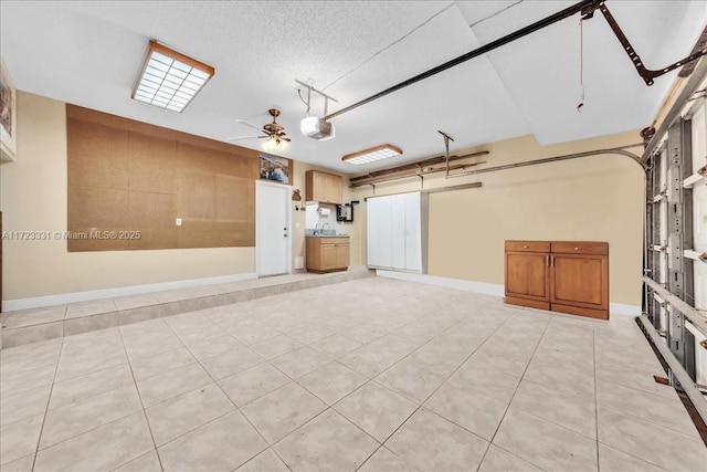 garage with a garage door opener and ceiling fan