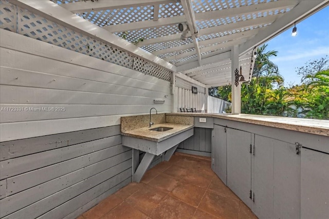 view of patio featuring sink and a pergola