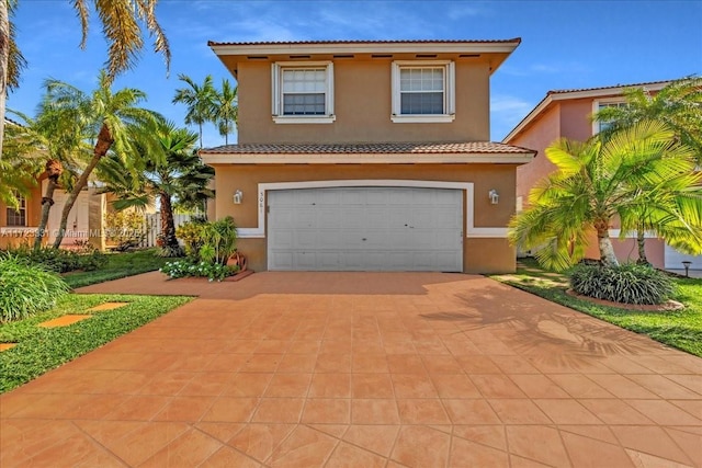 mediterranean / spanish home with a garage