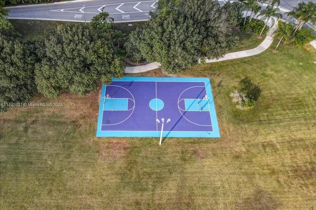 view of basketball court with a lawn