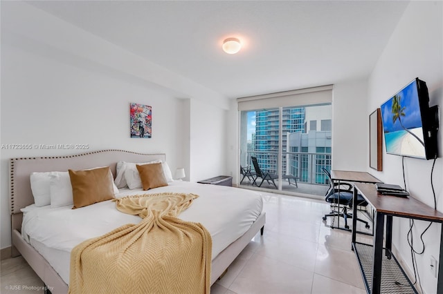 bedroom featuring a wall of windows and access to exterior