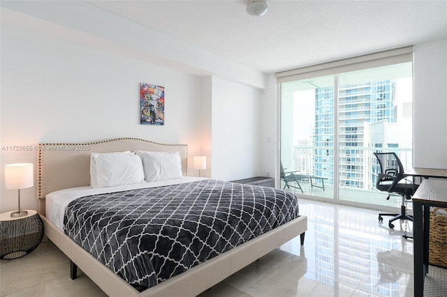 bedroom featuring access to outside and a wall of windows