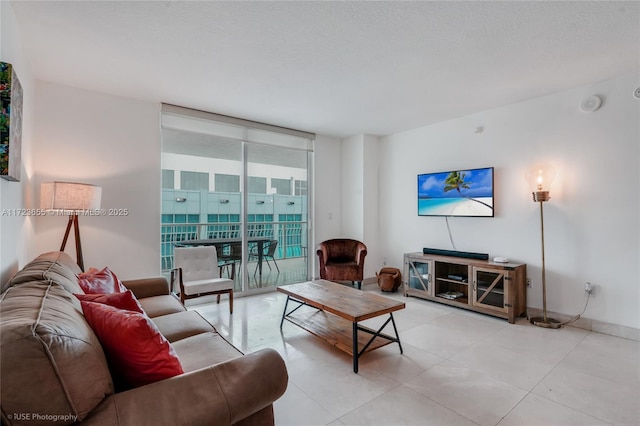 living room featuring a textured ceiling and a wall of windows