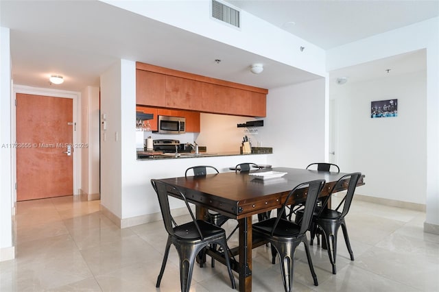 dining space with light tile patterned flooring