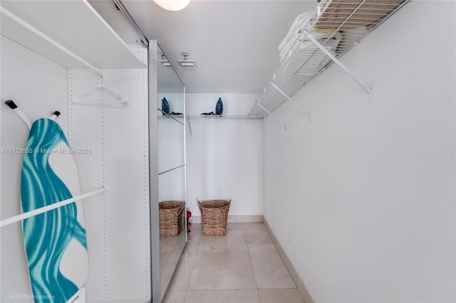 spacious closet featuring light tile patterned floors