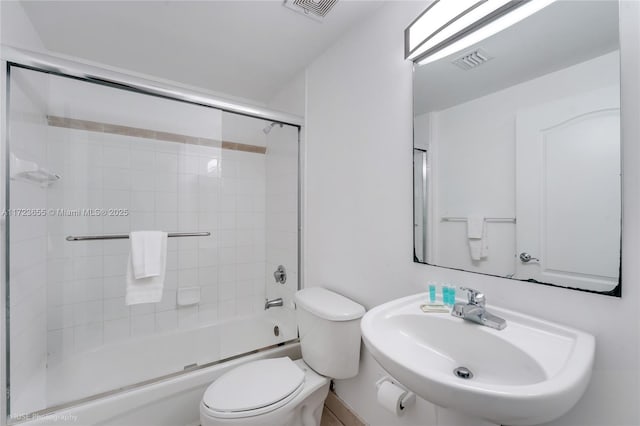 full bathroom with toilet, enclosed tub / shower combo, and sink