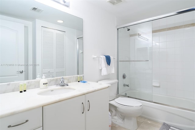 full bathroom with toilet, tile patterned floors, vanity, and enclosed tub / shower combo