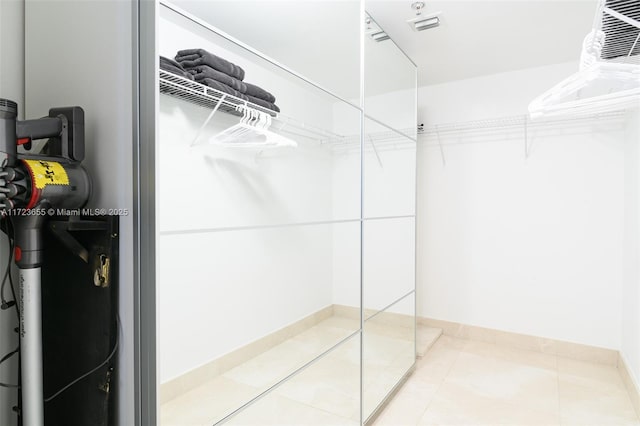 walk in closet with tile patterned floors