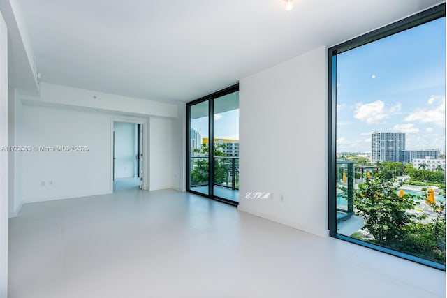 unfurnished room with expansive windows