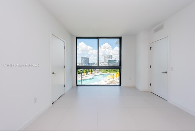 spare room featuring floor to ceiling windows