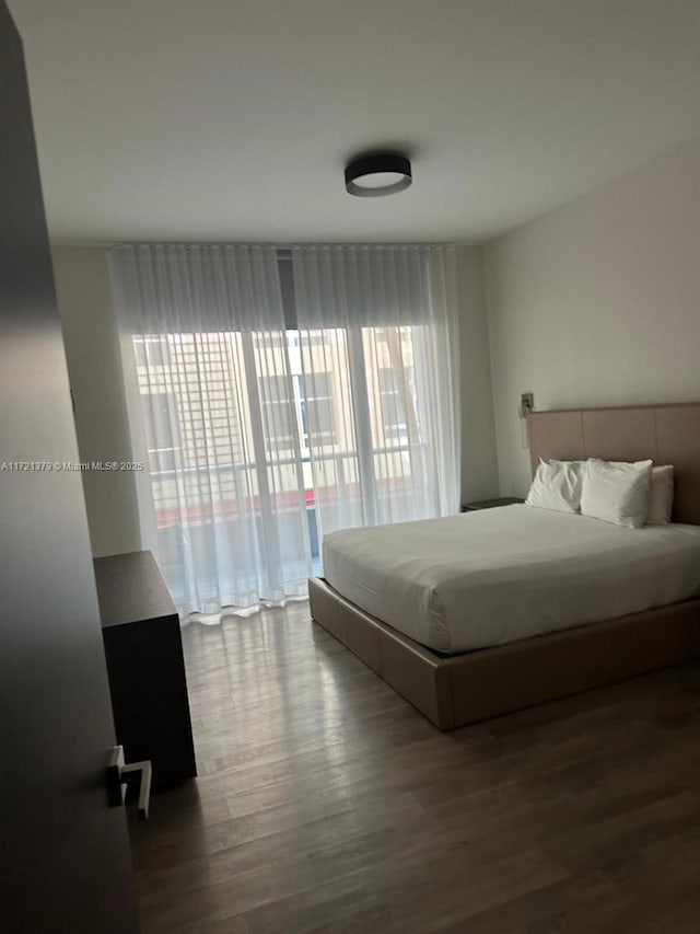 bedroom with wood-type flooring