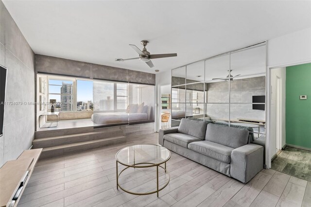 3 Island Ave Pha, Pha, Miami Beach, FL 33139 - living area with wood finished floors, a ceiling fan, and tile walls