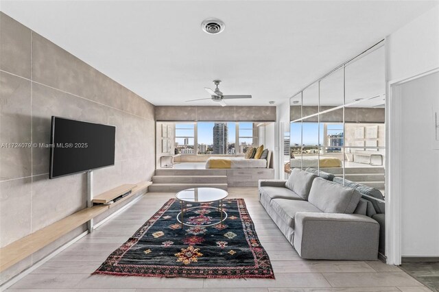 3 Island Ave Pha, Pha, Miami Beach, FL 33139 - living room featuring wood finished floors, a ceiling fan, visible vents, and plenty of natural light
