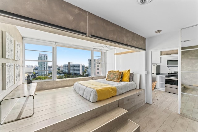 3 Island Ave Pha, Pha, Miami Beach, FL 33139 - bedroom with freestanding refrigerator, light wood finished floors, and a view of city